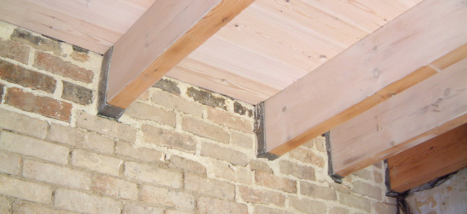 Bespoke Douglas Fir floor joists with lead covers to stop damp penetration